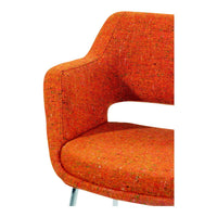 Vibrant orange upholstered chair with a textured pattern, showcasing a modern design and sleek silhouette.