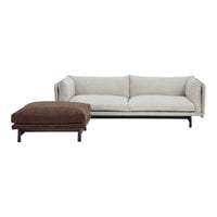 Modern sofa set featuring a soft beige upholstery and a rich brown ottoman, complemented by sleek black metal legs.
