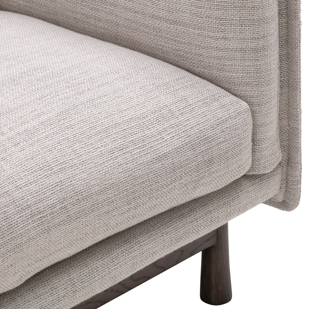 Light gray textured upholstery with a subtle woven pattern on a modern sofa cushion. Elegant and minimalistic design.