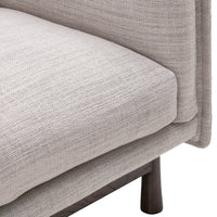 Light gray textured upholstery with a subtle woven pattern on a modern sofa cushion. Elegant and minimalistic design.