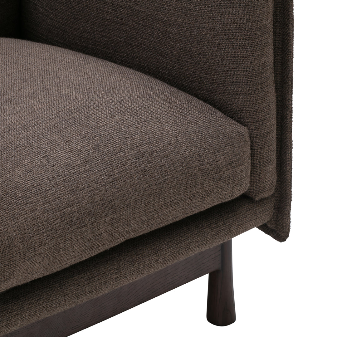 Brown textured fabric with a subtle pattern, featuring a sleek design and sturdy legs. Perfect for modern decor.