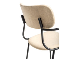 Beige upholstered chair with a minimalist design and sleek black metal frame.