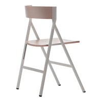 Minimalist modern chair with a soft pink wood seat and white metal frame, showcasing clean lines and a sleek design.