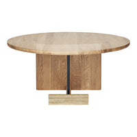 Round wooden dining table with a light oak finish and a smooth surface, featuring a sleek, minimalist base in natural tones.