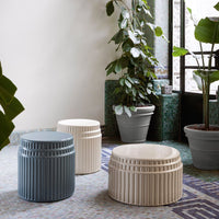 Set of three textured stools in cream, blue, and gray, featuring ribbed patterns for a modern aesthetic.