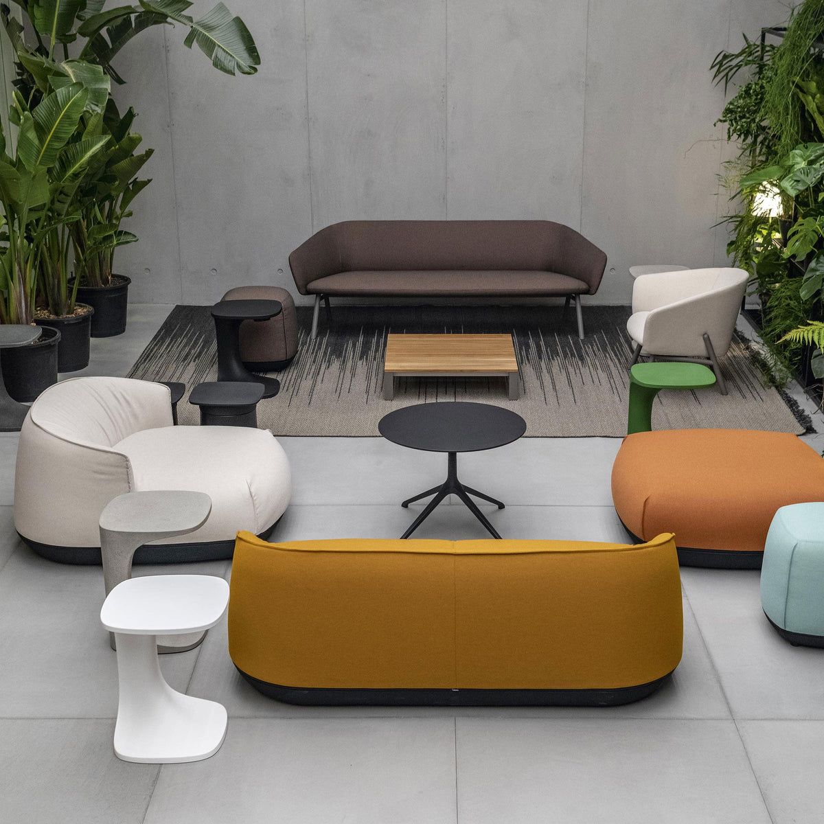Modern seating collection featuring brown, gray, orange, light blue, and white fabrics with geometric patterns.