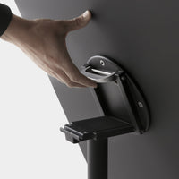 Close-up of a sleek, matte black handle and base with a subtle gray mechanism, showcasing modern design elements.