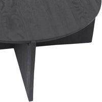 Round black wooden coffee table with a smooth finish and sleek geometric design.