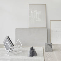 Minimalist decor featuring gray tones and geometric patterns in white and black. Elegant and modern style accent.