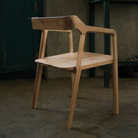 Light wood chair with a smooth, natural finish and minimalist design, showcasing clean lines and a simple silhouette.