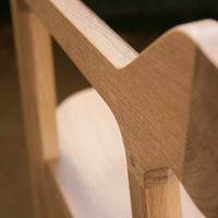 Light wood chair with a smooth finish, showcasing natural grain patterns and a minimalist design.