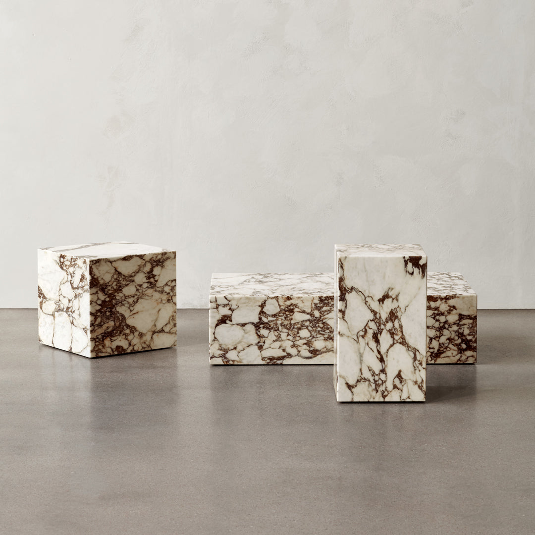 Elegant marble blocks in creamy white with rich brown veining, showcasing unique natural patterns. Perfect for modern decor.