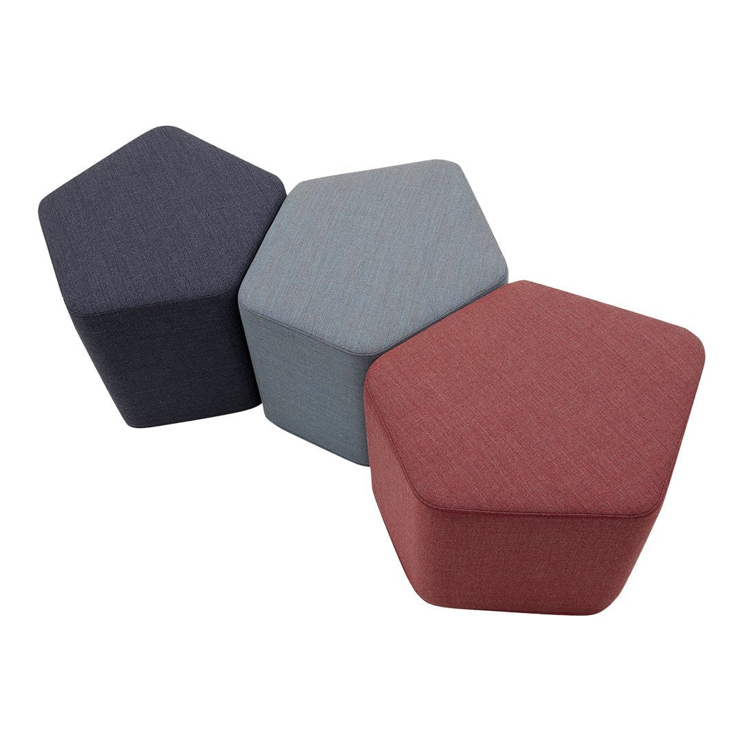 Hexagonal poufs in navy, light blue, and rust red, featuring textured fabric patterns for modern decor.