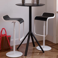 Black and white modern bar stools paired with a sleek black table, featuring minimalist design and elegant colors.
