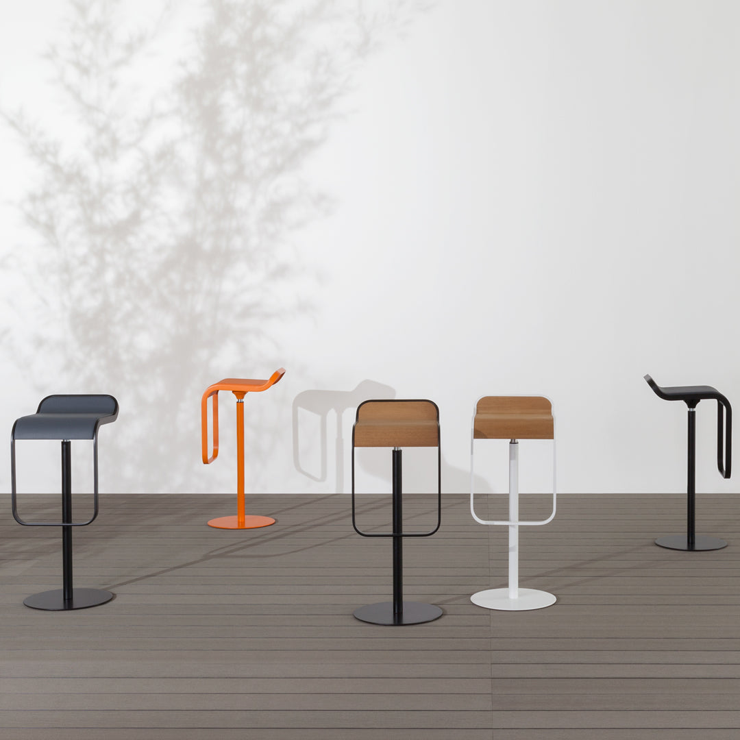 Colorful modern bar stools featuring orange, brown, black, and white finishes with sleek, contemporary designs.