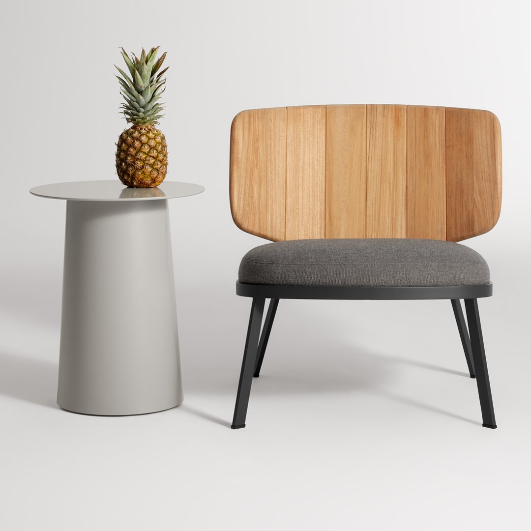 Gray upholstered chair with a wooden slatted back, paired with a round gray side table and a pineapple.