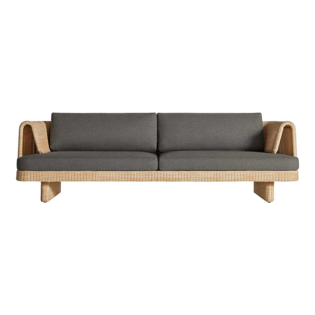 Gray upholstered sofa with natural woven rattan accents and a modern minimalist design, perfect for chic interiors.