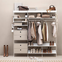Stylish open wardrobe in soft beige and white tones, featuring a minimalistic design and neutral-hued clothing.