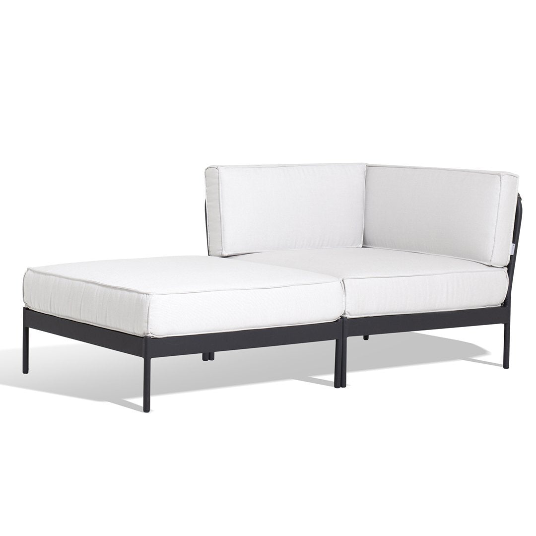 Modern white outdoor sectional sofa with black metal frame, featuring clean lines and a minimalist design.