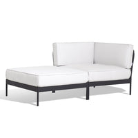 Modern white outdoor sectional sofa with black metal frame, featuring clean lines and a minimalist design.