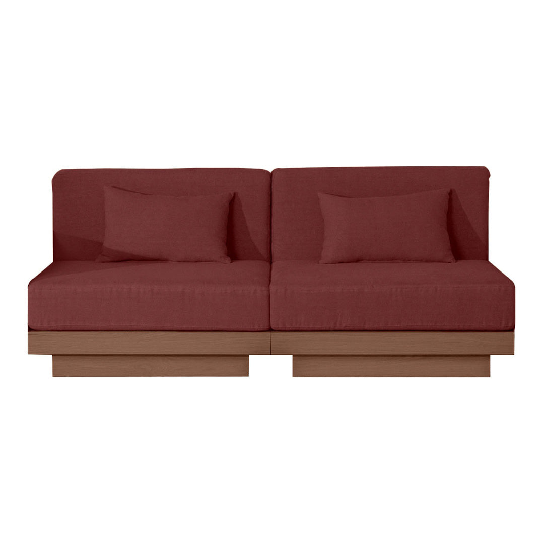 "Rustic burgundy sofa with a smooth fabric finish and minimalist wooden base, featuring two matching pillows."