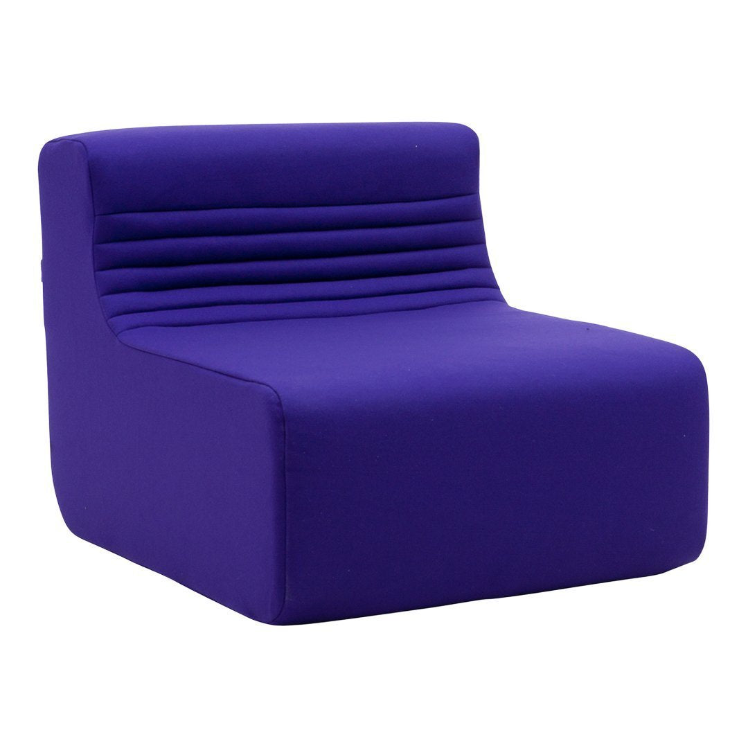 Vibrant purple lounge chair with a sleek, minimalist design and subtle ribbed detailing on the backrest.