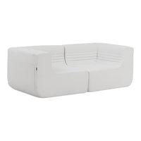 Modern white sofa with sleek lines and subtle ribbed texture, perfect for minimalist decor.