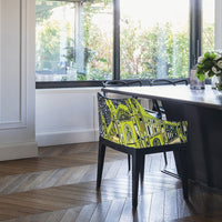 Vibrant yellow and black patterned chair, perfect for adding a pop of color to modern interiors.
