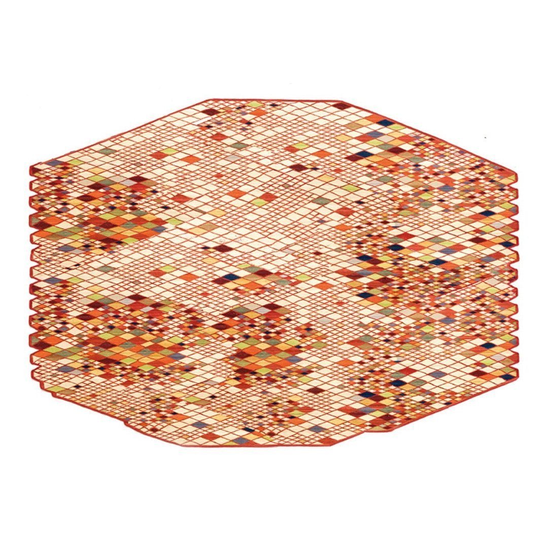 Hexagon rug featuring a vibrant pattern of warm colors, including orange, red, yellow, and hints of blue and brown.