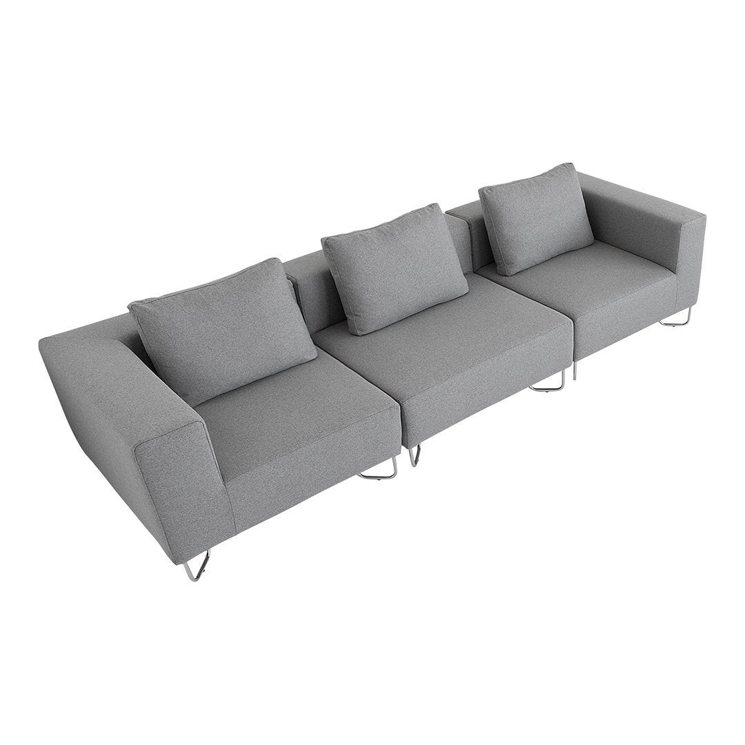 Gray sectional sofa with sleek lines and minimalist design, featuring matching throw pillows.
