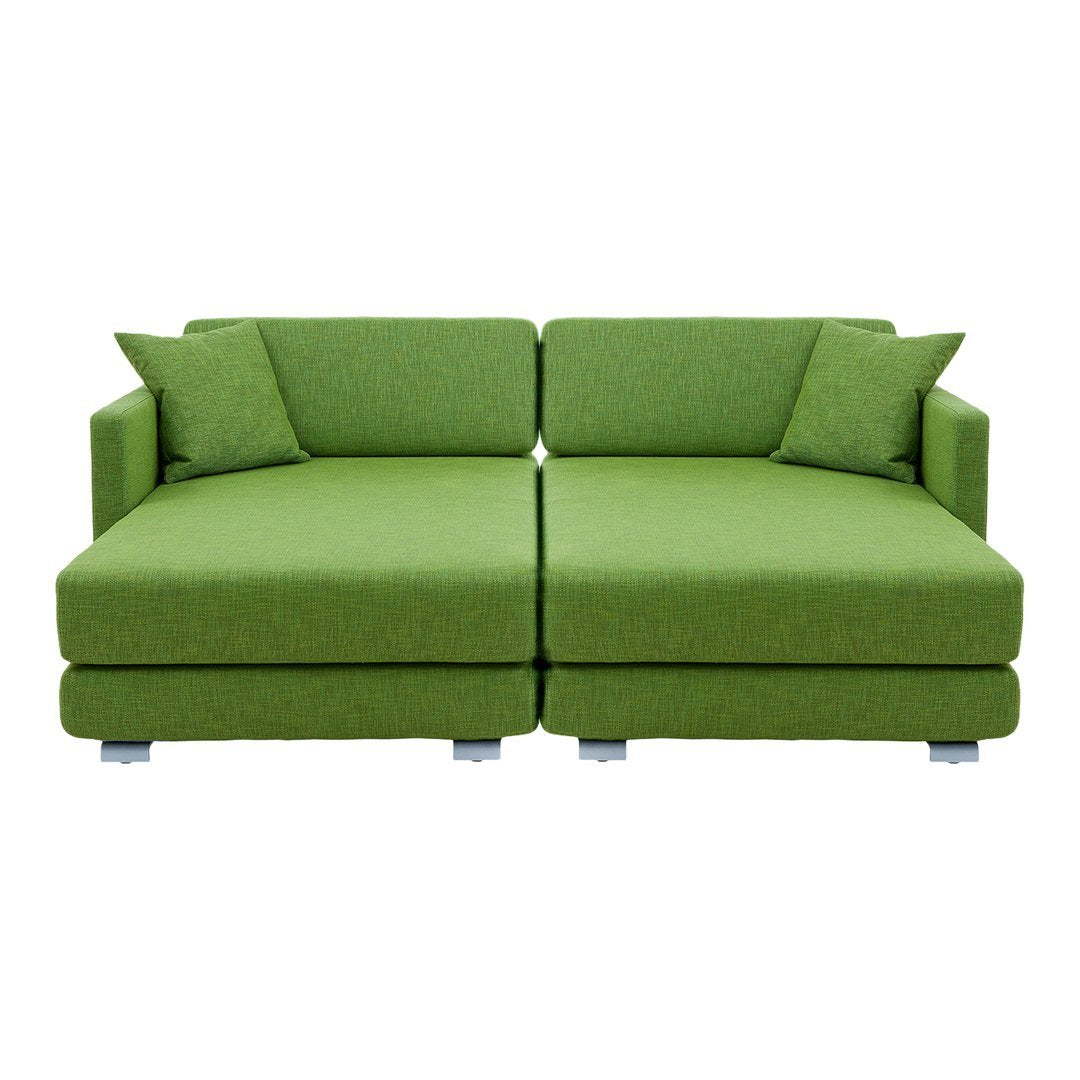 Green modern sectional sofa with textured fabric and matching cushions, perfect for vibrant living spaces.