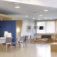 Office interior featuring blue and neutral tones with wooden accents, sleek furniture, and modern light fixtures.