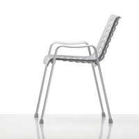 Gray ergonomic chair with a sleek design and perforated backrest for optimal ventilation and style.