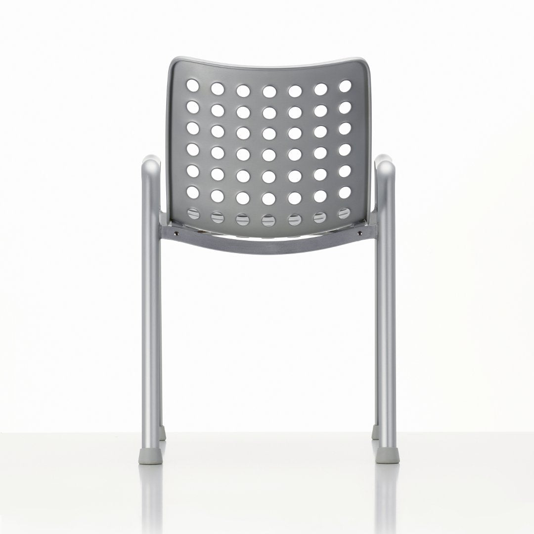 Gray chair with a perforated backrest and silver metal legs against a white background.