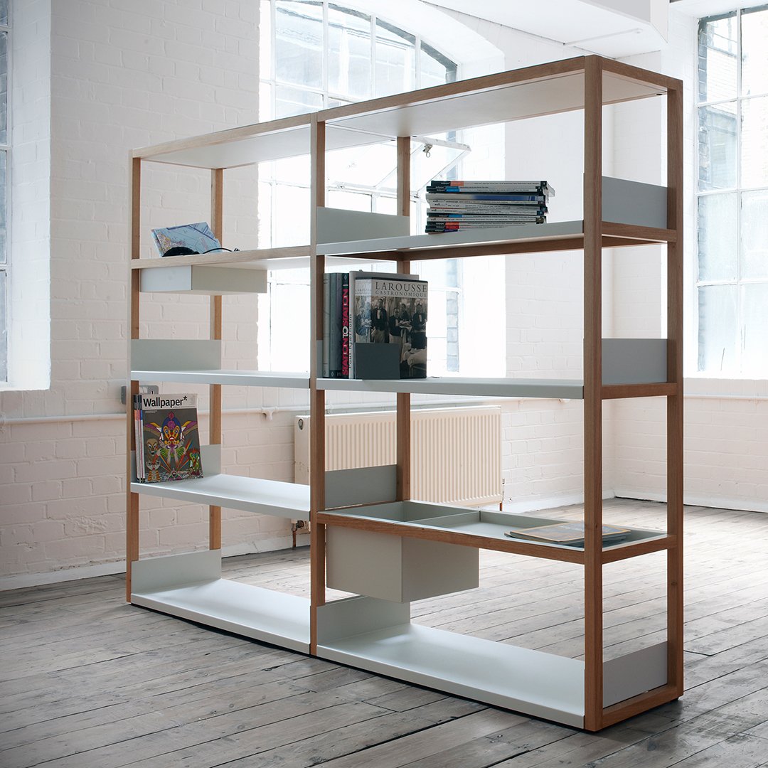 Wooden shelf with natural wood finish, white shelves, and minimalist design, set against a bright interior backdrop.