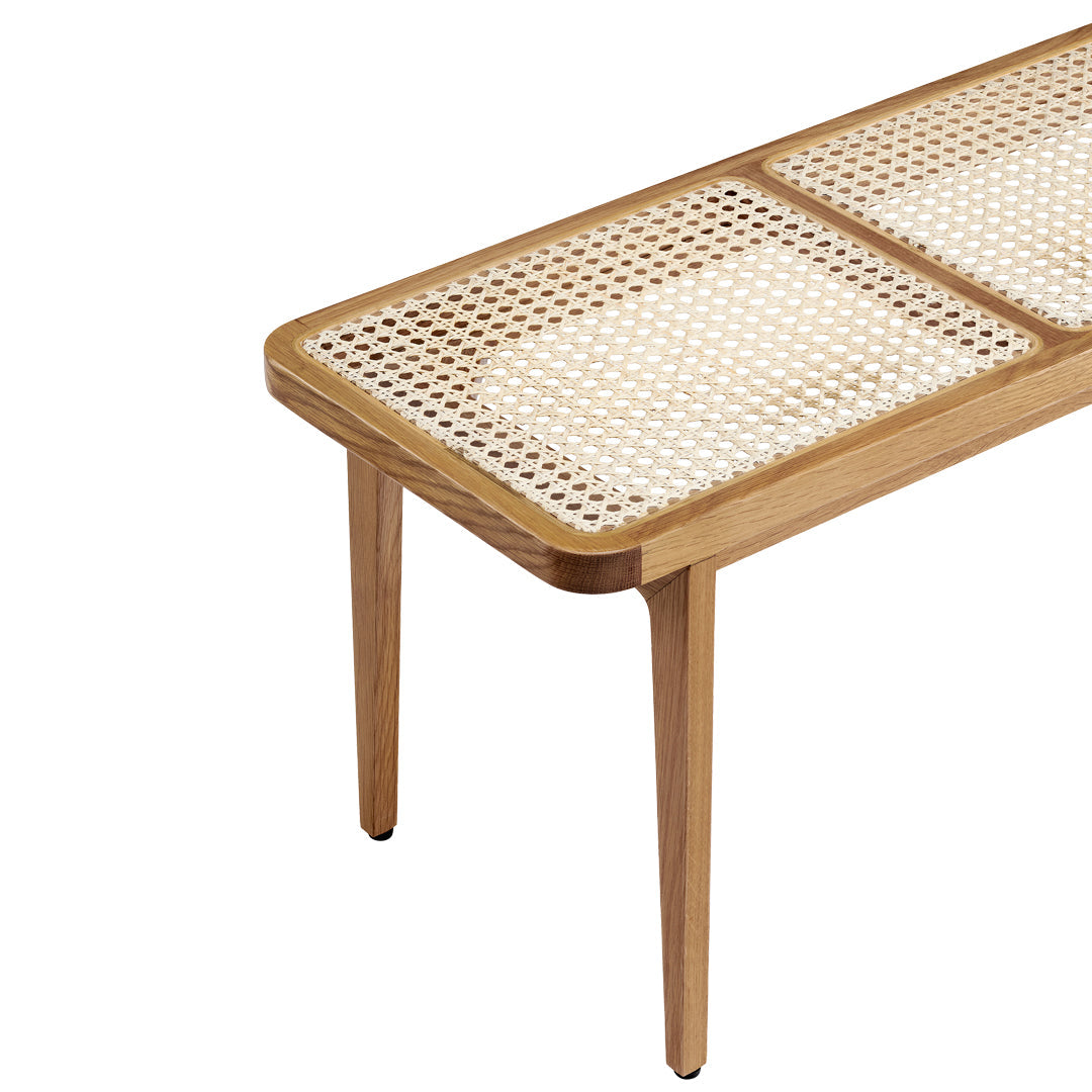 Natural wood coffee table with a light brown finish and woven cane pattern on the tabletop.