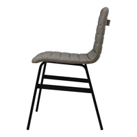 Side view of a gray quilted chair with a sleek black metal frame, showcasing a modern design and neutral tones.