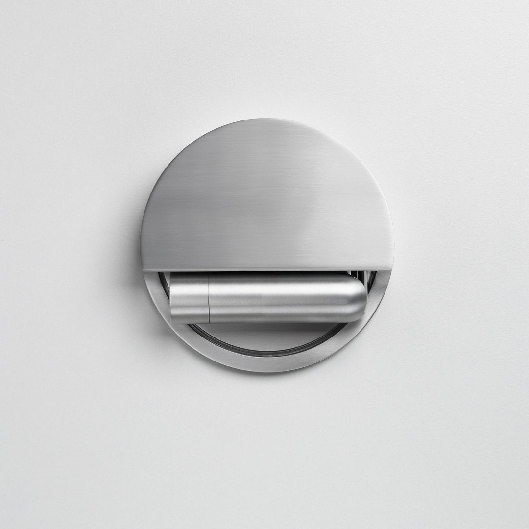 Sleek stainless steel round wall-mounted toilet paper holder with a minimalistic design and smooth finish.