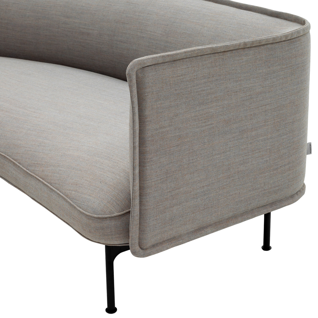 Grey upholstered sofa with subtle textured pattern and sleek black metal legs. Minimalist design for modern interiors.