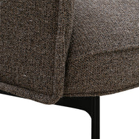 Brown textured fabric detail with subtle gray flecks on a modern chair, featuring a sleek black metal base.
