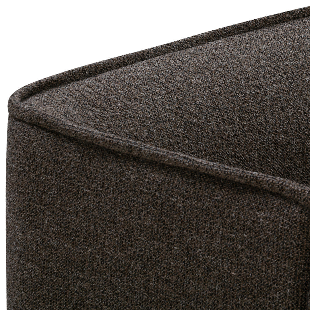 Brown textured fabric with a subtle weave pattern on a cushioned surface. Ideal for stylish home décor.