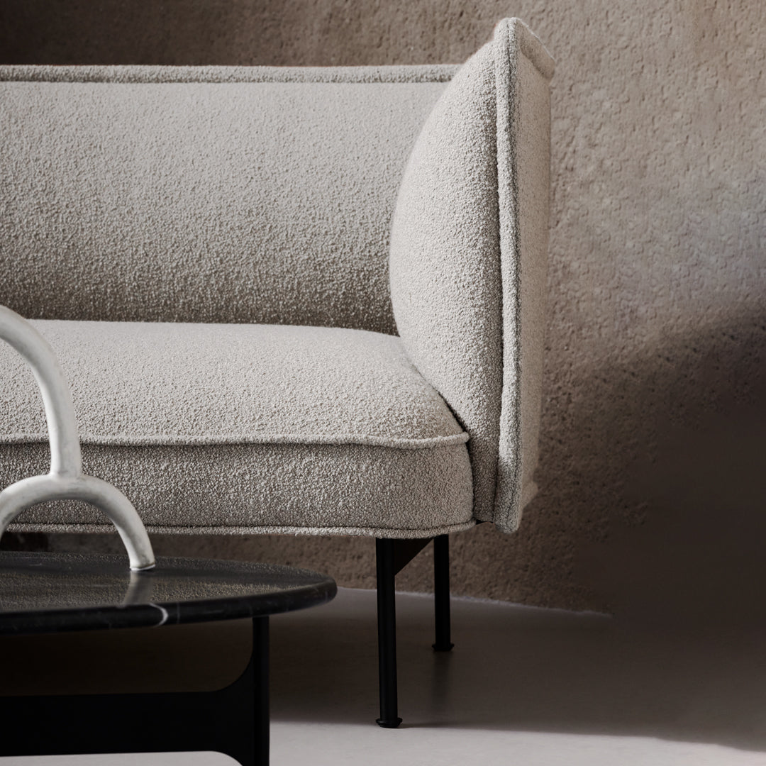 Light beige boucle upholstery on a contemporary sofa, featuring clean lines and a minimalist design.