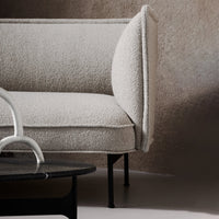 Light beige boucle upholstery on a contemporary sofa, featuring clean lines and a minimalist design.