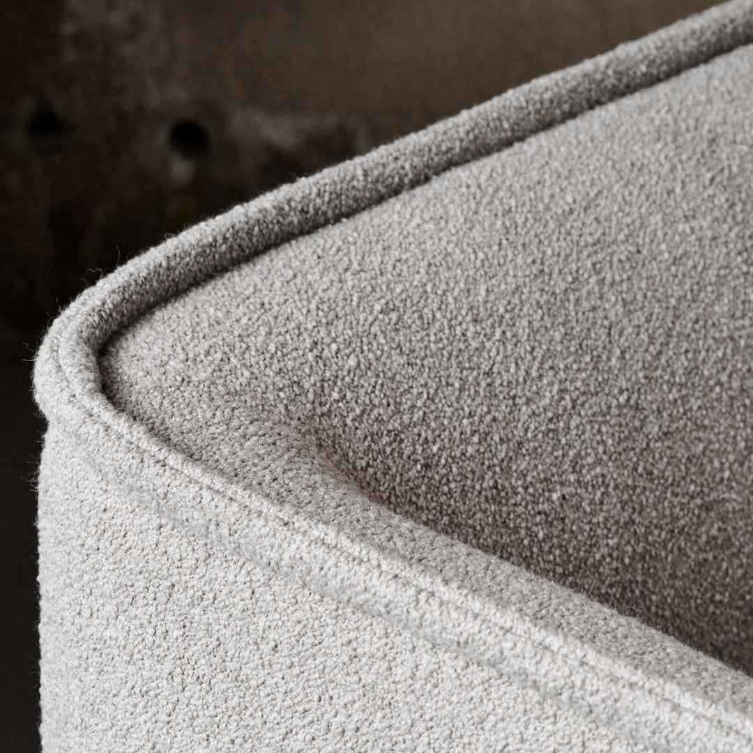 Textured light gray fabric with a soft, subtle pattern, showcasing a modern, minimalist design.