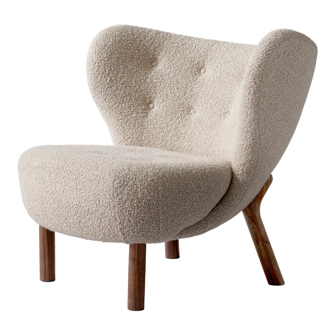 Cream-colored chair with a textured, fluffy upholstery and wooden legs. Elegant mid-century modern design.