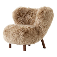 Fluffy beige faux fur chair with curved silhouette and wooden legs, perfect for cozy, stylish seating.