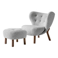 Gray tufted accent chair and matching ottoman with wooden legs, showcasing a sleek, modern design.