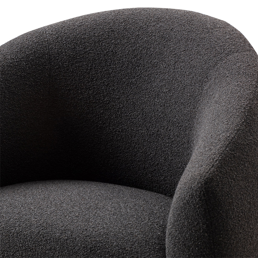 Dark gray textured upholstery on a stylish armchair, showcasing a modern and cozy design.