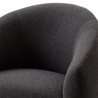 Dark gray textured upholstery on a stylish armchair, showcasing a modern and cozy design.