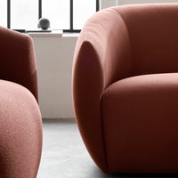 Textured rosy pink fabric with smooth, rounded shapes, creating a modern and cozy seating design.